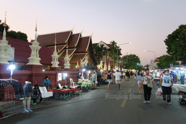 Tourists shop on a walking street in Muang district of Chiang Mai province on Feb 20, 2022. (Photo: Punsita Ritthikarn)