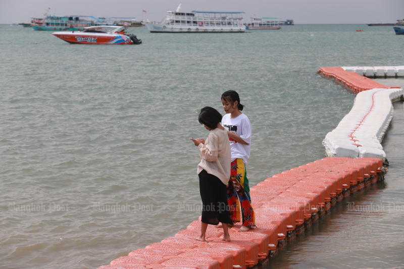 Tourists are seen on Pattaya beach on March 24, 2022. The Tourism Authority of Thailand hopes for more domestic travel from Thais to shore up the sector. (Photo: Somchai Poomlard)