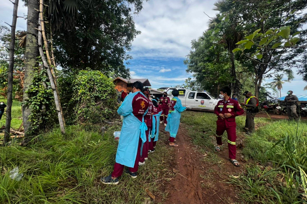 Rescuers look at a sugar palm tree on Wat Bot district of Phitsanulok province from where a man fell to death after climbing up to tap palm milk on Sunday. (Photo: Chinnawat Singha)