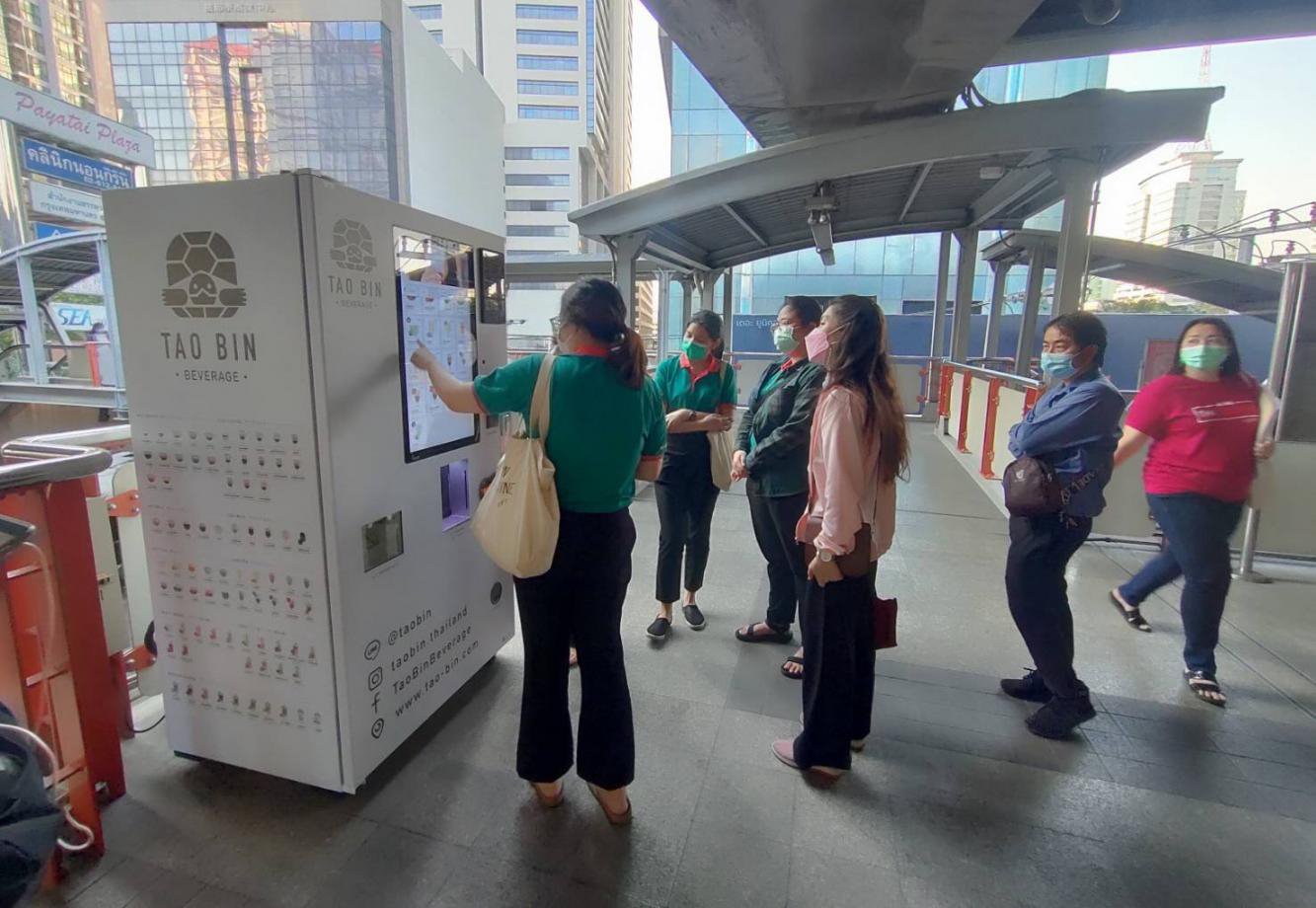 Customers use a Tao Bin vending machine at BTS Phaya Thai station. There were 500 Tao Bin machines in the market last year.