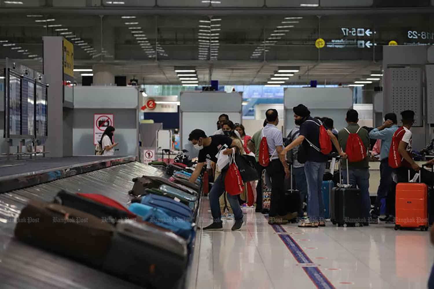 Travelers collect their baggage at Suvarnabhumi airport in Samut Prakan province on May 1. (Photo: Wichan Charoenkiatpakul)