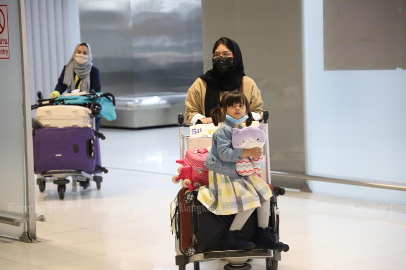 People emerge from the arrival hall at Suvarnabhumi airport after disembarking from a Saudi Arabian Airlines flight SV846 from Jeddah via Riyadh on Feb 27, 2022. (Photo: Varuth Hirunyatheb)