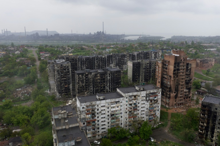 Charred residential buildings in Mariupol with the Azovstal steel plant in the background Charred residential buildings in Mariupol with the Azovstal steel plant in the background