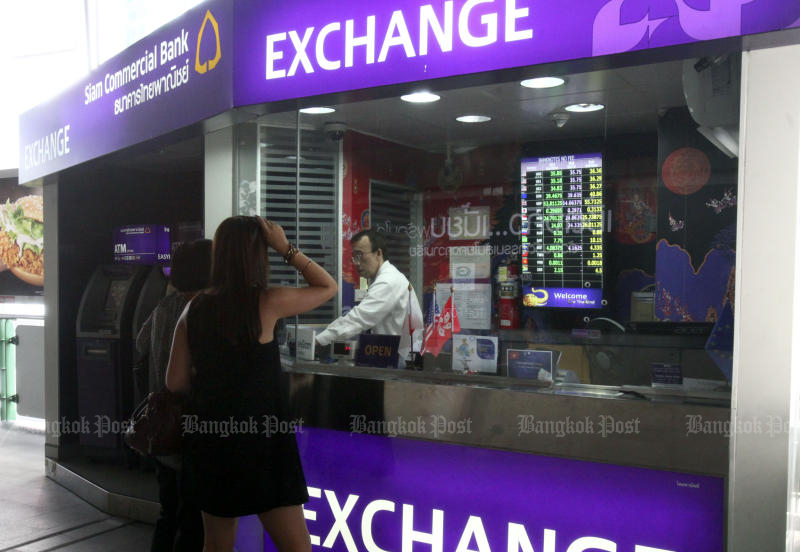 The baht will weaken further throughout this month because of higher volatility in money and capital markets worldwide, according to economists. (Bangkok Post file photo)