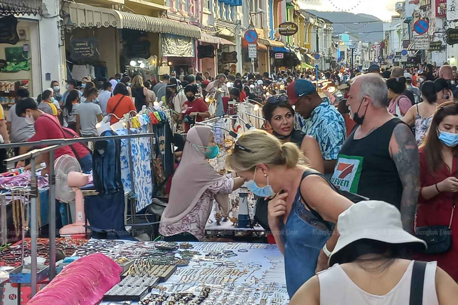 Tourists throng a market street in the old town area of Phuket on Sunday. (Photo: Achadthaya Chuenniran)