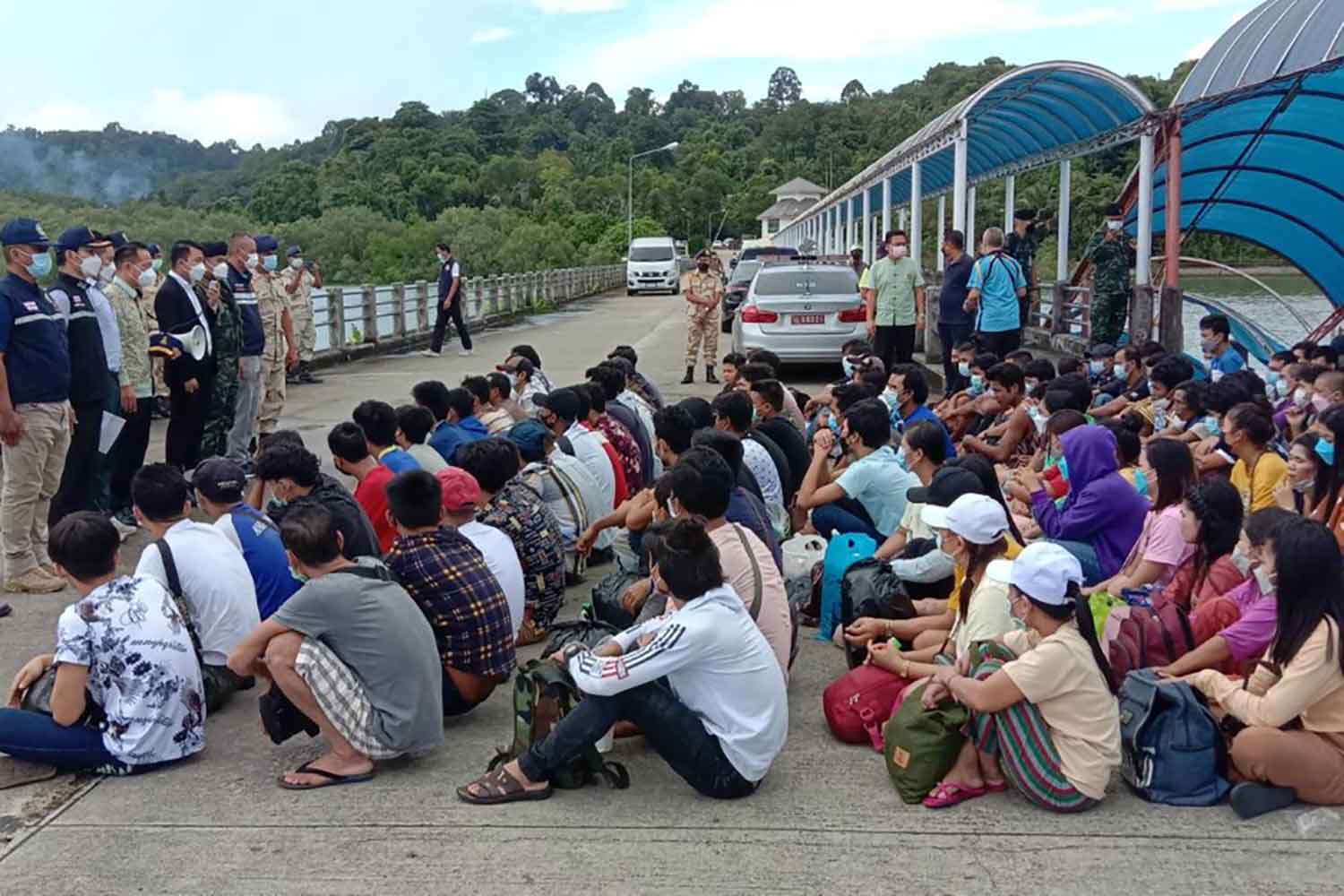 The 166 illegal Myanmar migrants wait at the customs boat pier in Ranong for repatriation on Wednesday. (Photo: Achadthaya Chuenniran)