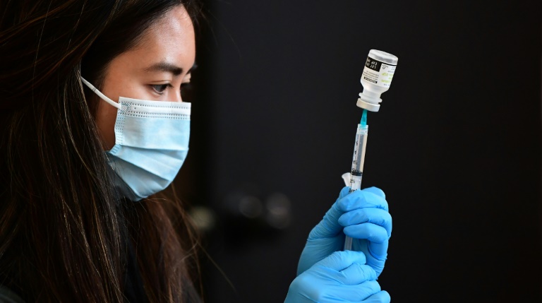 A health worker prepares to administer a vaccine in Los Angeles, California in January 2022 A health worker prepares to administer a vaccine in Los Angeles, California in January 2022