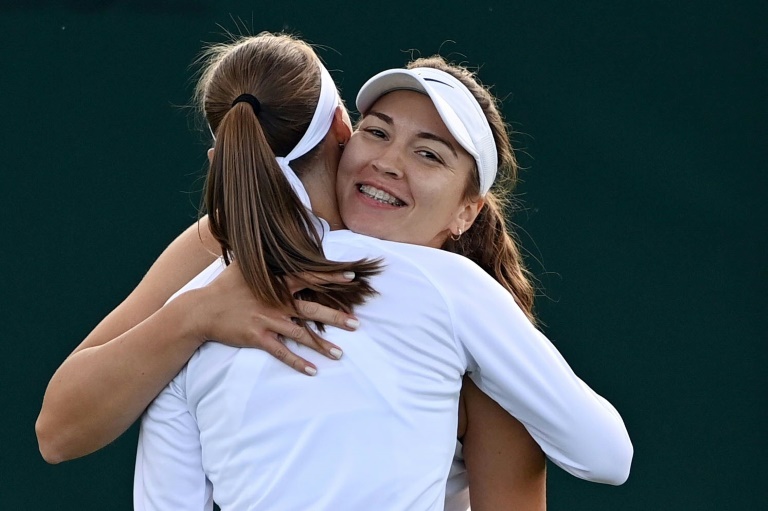 All change: Russian-born Georgian player Natela Dzalamidze (right) hugs partner Aleksandra Krunic after winning their women's doubles match on Thursday All change: Russian-born Georgian player Natela Dzalamidze (right) hugs partner Aleksandra Krunic after winning their women's doubles match on Thursday