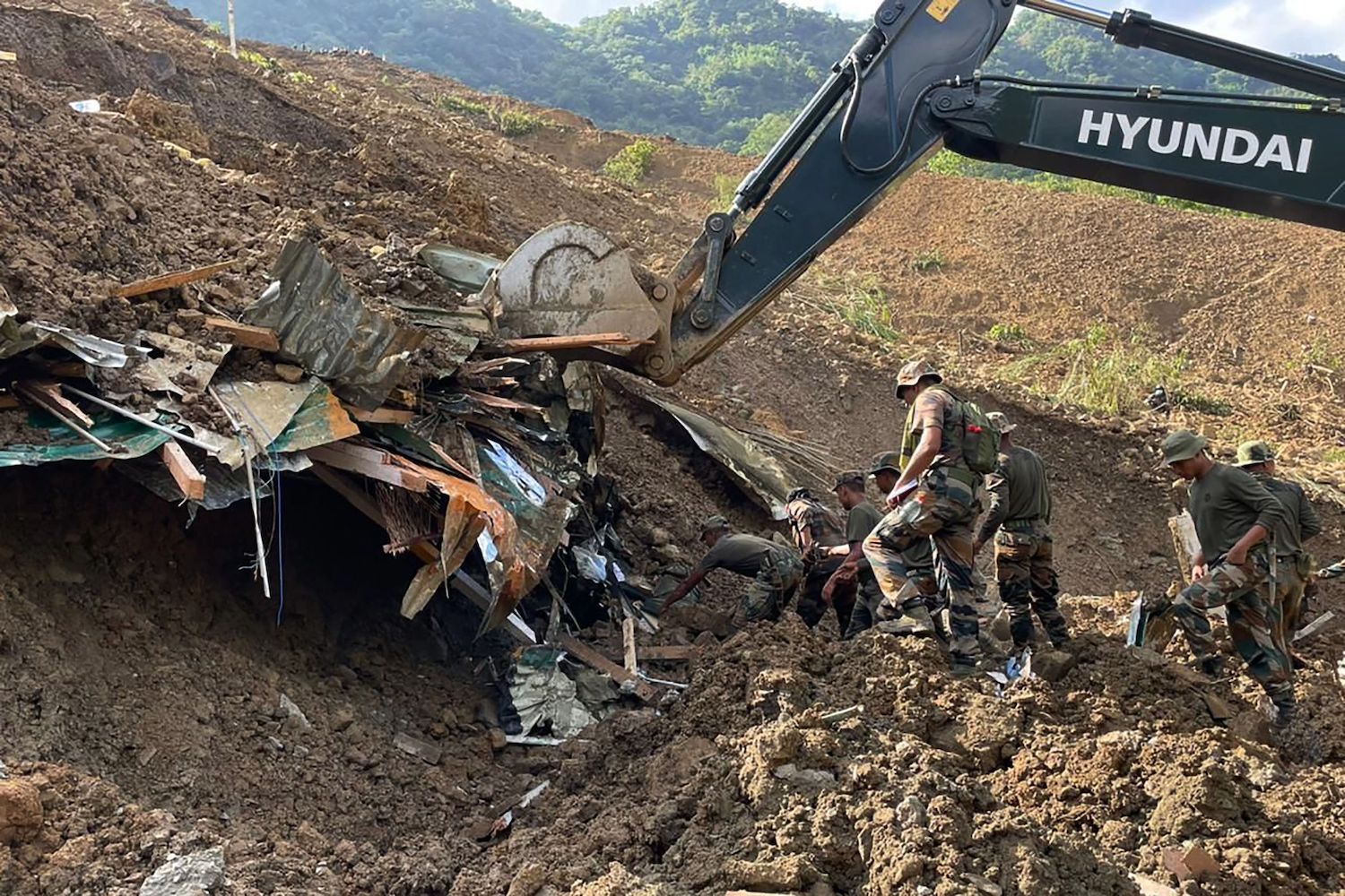Security forces and disaster relief teams search for survivors and victims after a landslide in Noney district in the northeastern Indian state of Manipur on Friday. (AFP Photo)