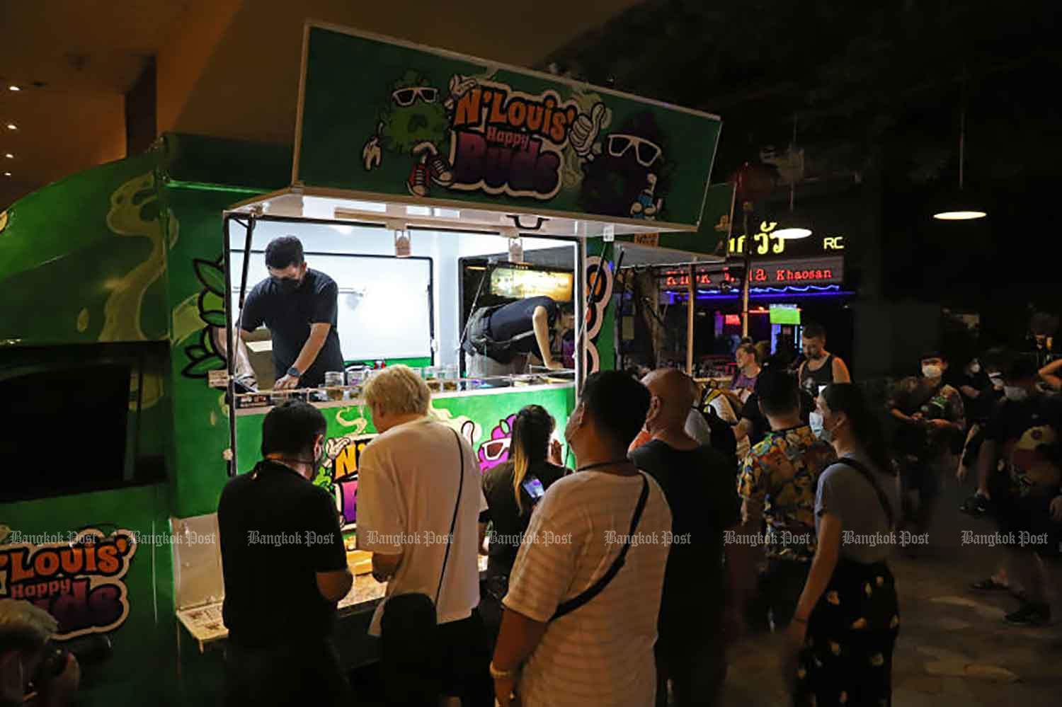 People buy cannabis from a mobile stall on Khao San Road in Bangkok last month. (Photo: Varuth Hirunyatheb)