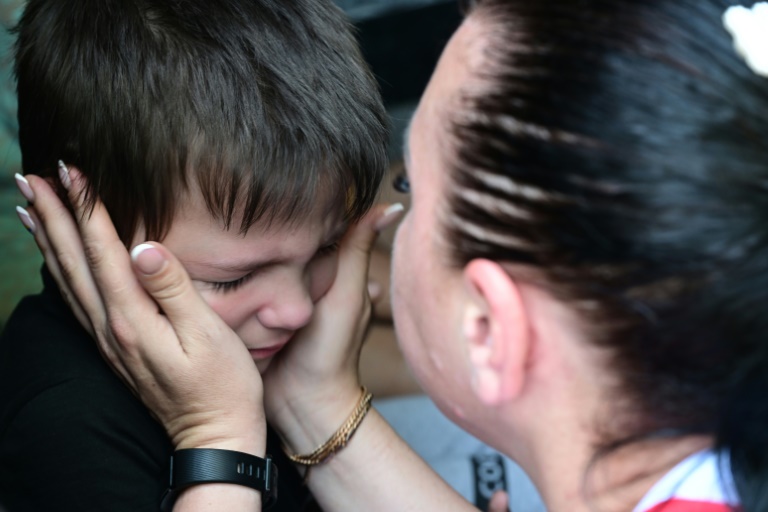 A woman says goodbye to her son before his evacuation from the city of Sloviansk on Wednesday. A woman says goodbye to her son before his evacuation from the city of Sloviansk on Wednesday.