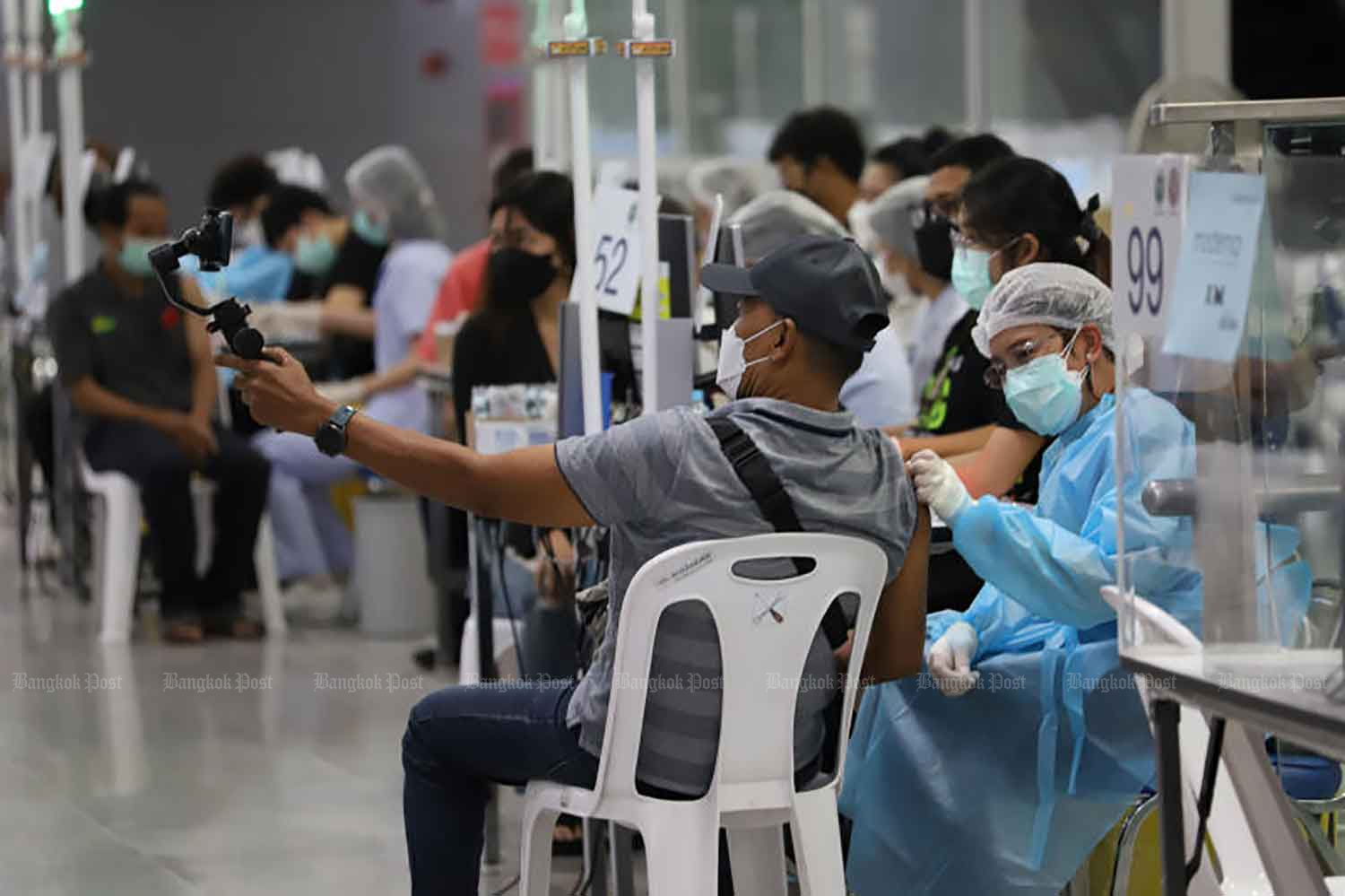 People receive Covid-19 vaccine at Bang Sue Grand Station in Bangkok. (Photo: Varuth Hirunyatheb)