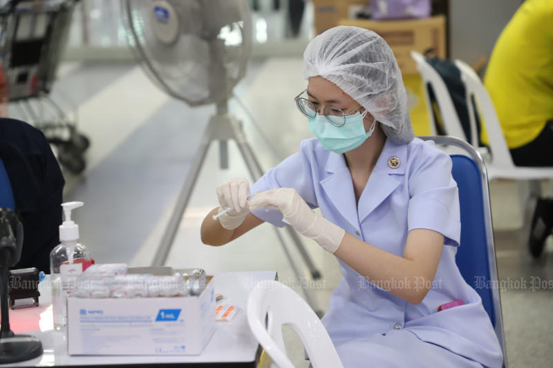 A nurse prepares a vaccine shot for people at Bang Sue Grand Station on July 6, 2022. (Photo: Varuth Hirunyatheb)