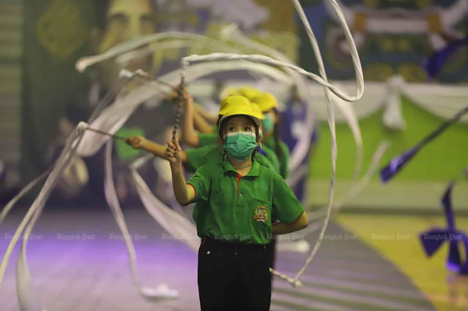 Youngsters take part in a parade at the opening of the Chang Noi Games, an annual sports competition for schools under City Hall's supervision, at the Bangkok Youth Centre in Din Daeng district on Tuesday, when the country recorded 2,747 new Covid-19 cases admitted to hospitals and 34 more fatalities related to the disease. (Photo: Pornprom Satrabhaya).