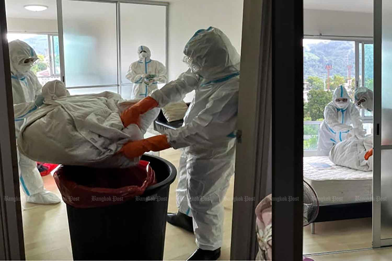 Disease control officials clean the room of the country's first monkeypox case in Phuket last month. (Photo: Department of Disease Control)