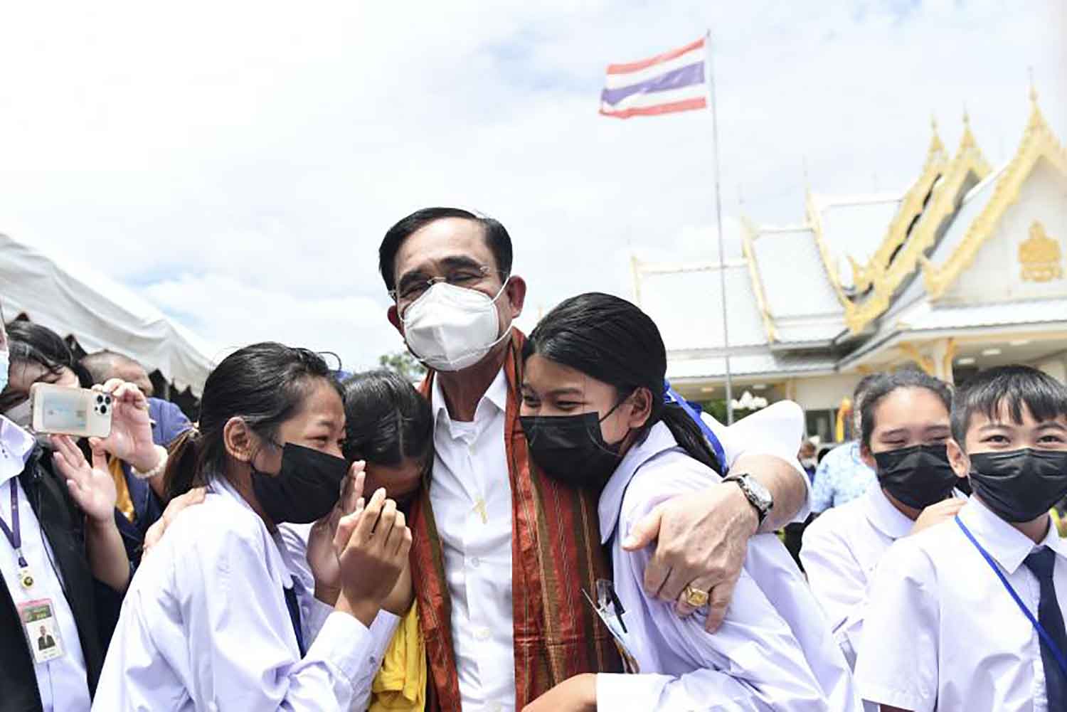 Prime Minister Prayut Chan-o-cha hugs students of Wat Don Chedi during his visit to Kanchanaburi on Thursday. Students and locals greeted him at King Naresuan Monument in Phanom Thuan district. (Government House photo)