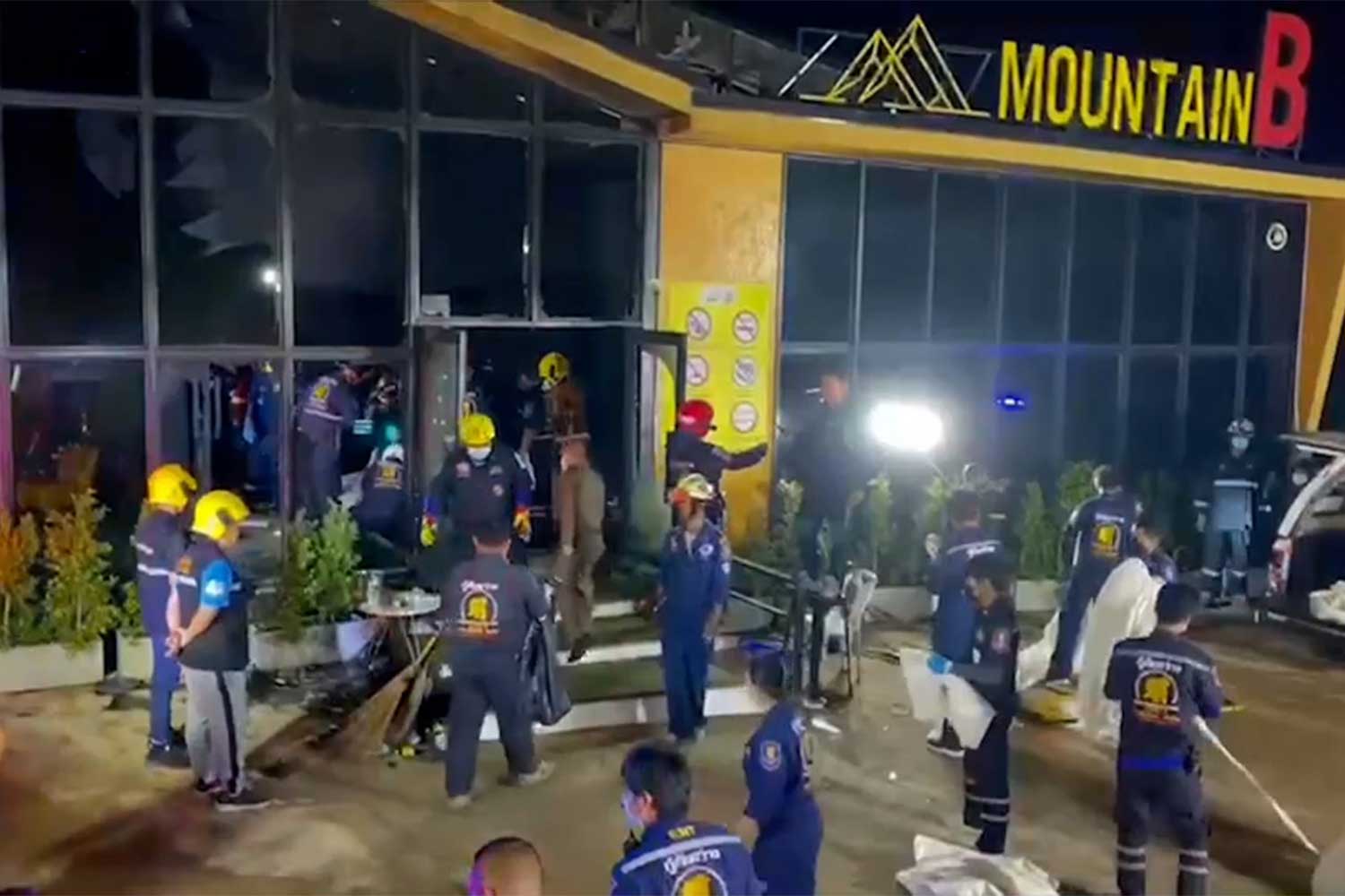 Police and rescue workers outside the fire-gutted Mountain B pub on Sukhumvit Road in Sattahip district of Chon Buri. Fourteen people died in the blaze and 38 others were injured. (Photo: Chaiyot Pupattanapong)