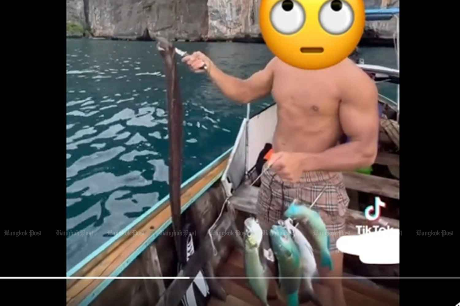 A screenshot from a video posted on TikTok shows the tourist with his illegal catch. (Photo supplied)