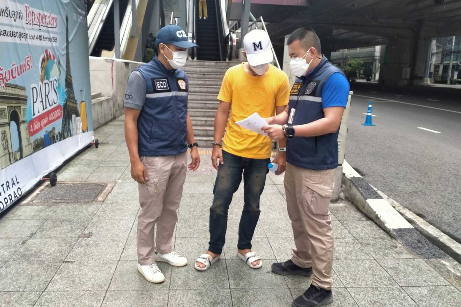 Police serve an arrest warrant on a man accused of filing a false claim for Covid-19 insurance payment. (Photo supplied)