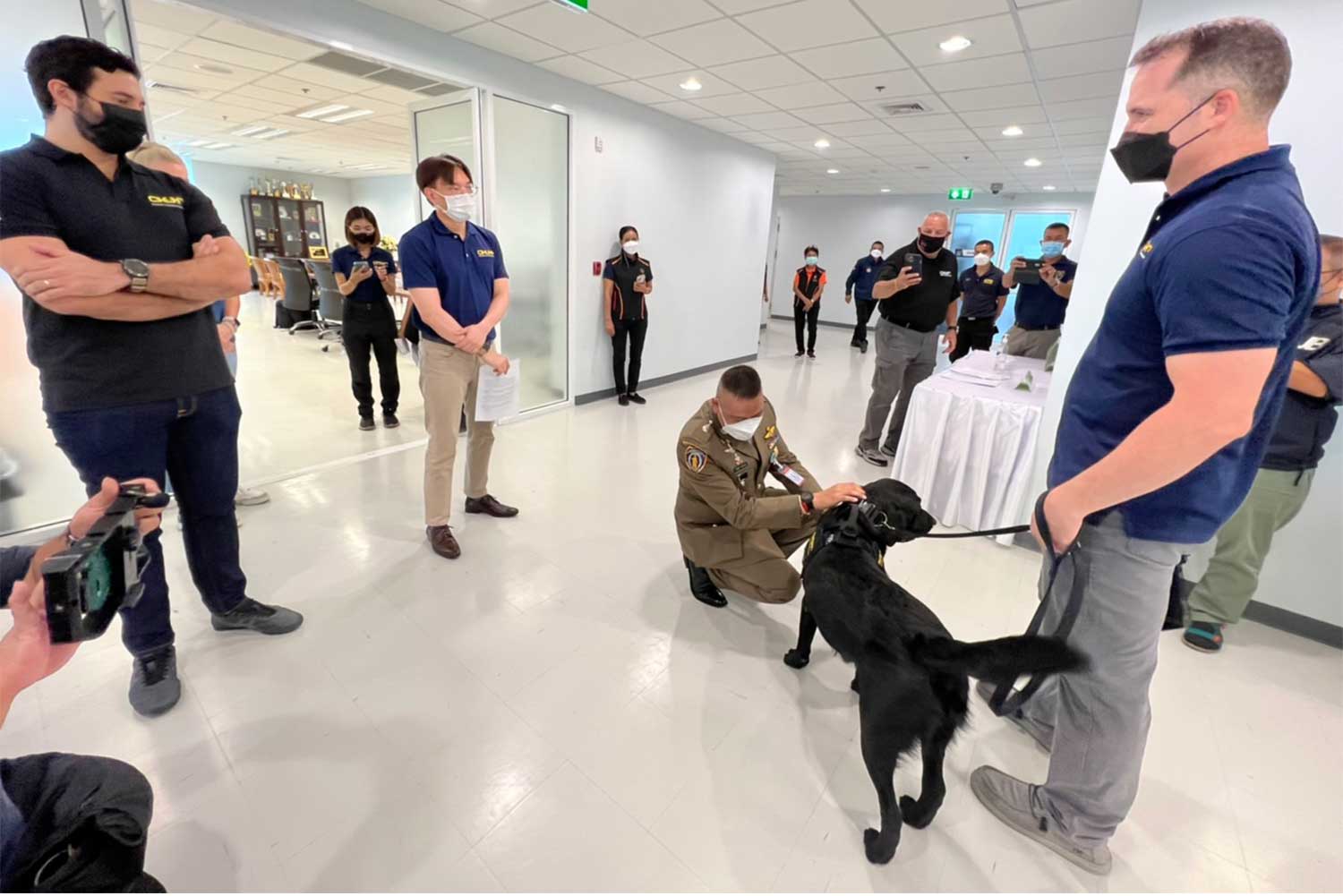 Representatives of the international organisation Operation Underground Railroad showcase their specially trained sniffing dog to police at the Anti-Trafficking in Persons Division on Thursday. (Photo: Wassayos Ngamkham)