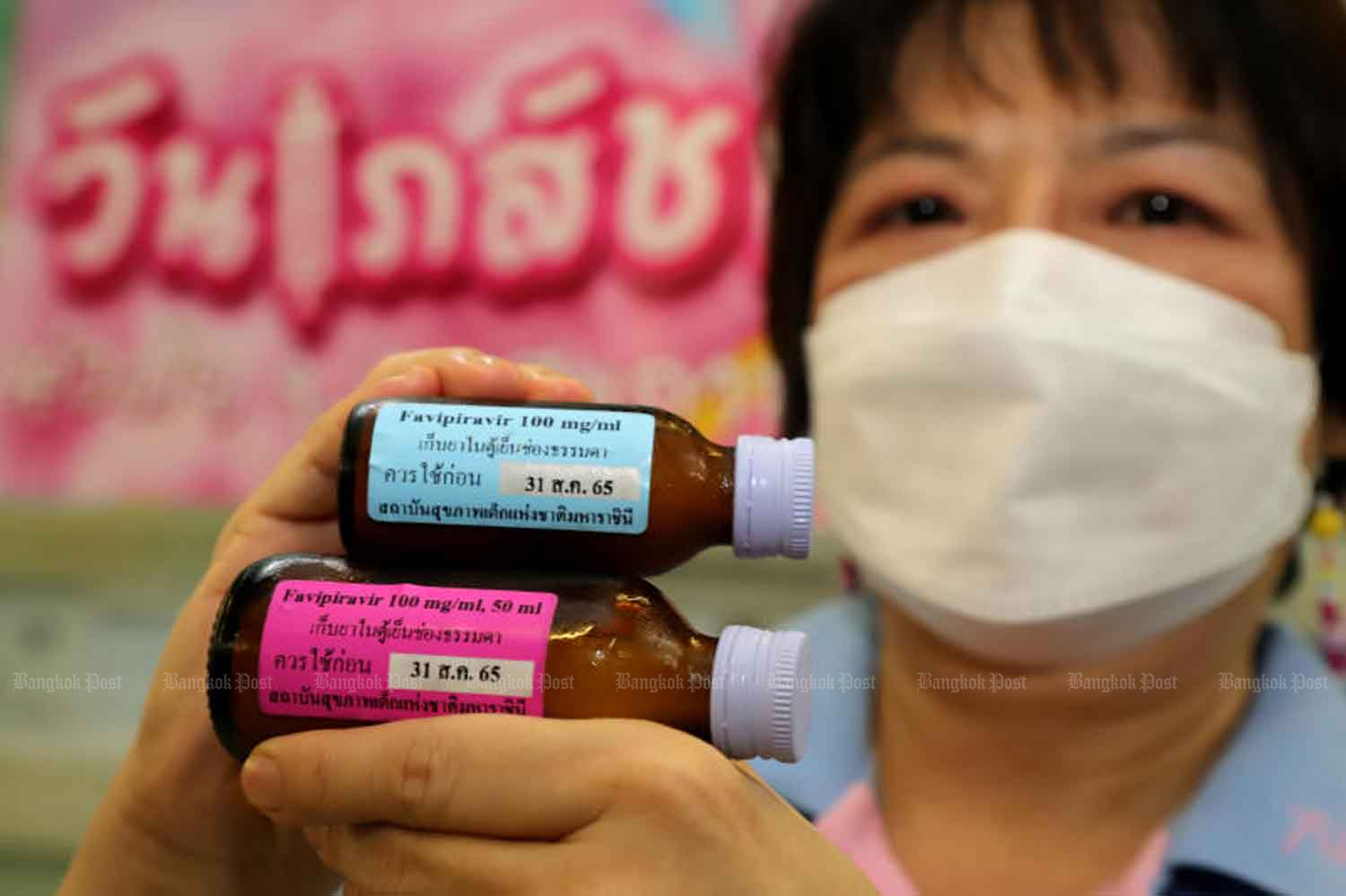 A health official shows a liquid favipiravir preparation, which was developed by the Queen Sirikit National Institute for Child Health to treat children with Covid-19. (Photo: Chanat Katanyu).