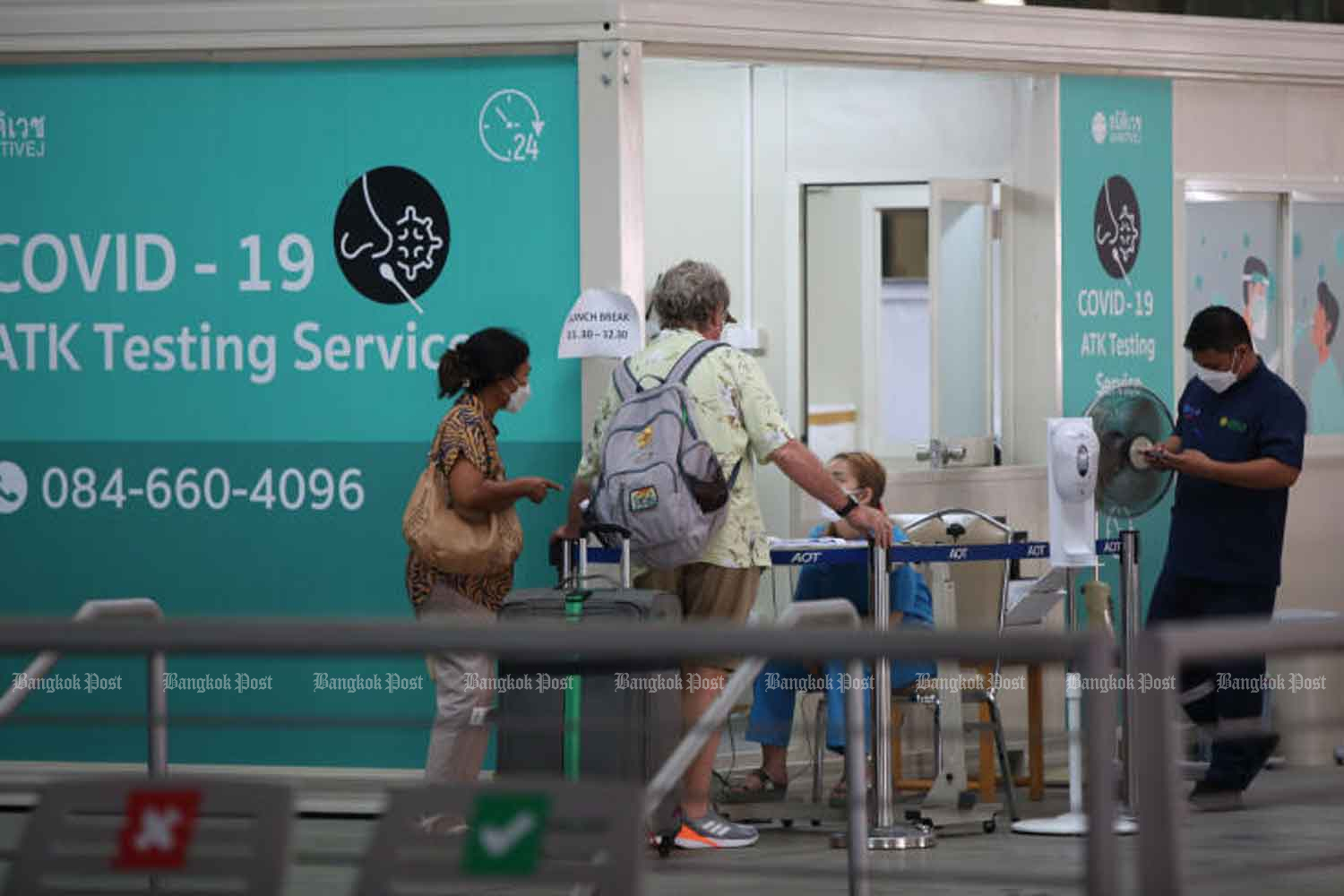 Travellers head for antigen tests for Covid-19 at Suvarnabhumi airport. (Photo: Varuth Hirunyatheb)