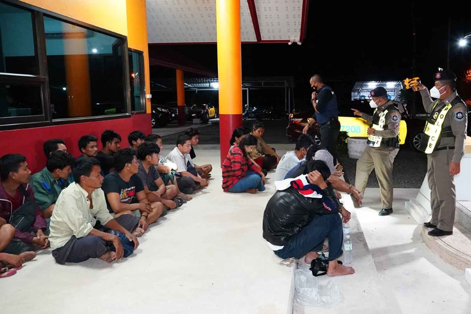 Some of the 71 illegal Myanmar migrants, at Na Khayat police station in Muang district, Phatthalung. They were caught on Monday by highway police while travelling in two vans heading for Hat Yai district in Songkhla. (Photo: Assawin Pakkawan)