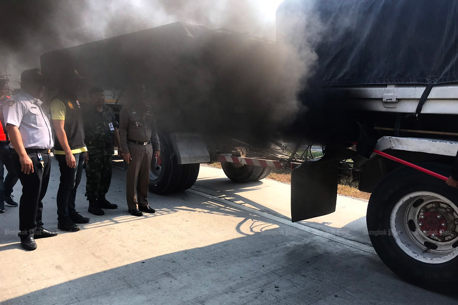 Police officers inspect truck emissions due to complaints about black smoke emitted from them. (Bangkok Post file photo)