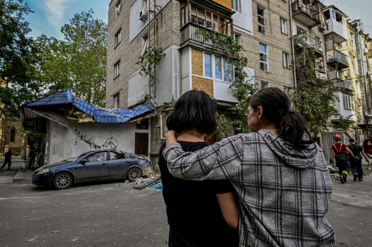 Women stand in front of a damaged residential building after shelling in the Ukrainian city of Mykolaiv, Ukraine on Saturday.