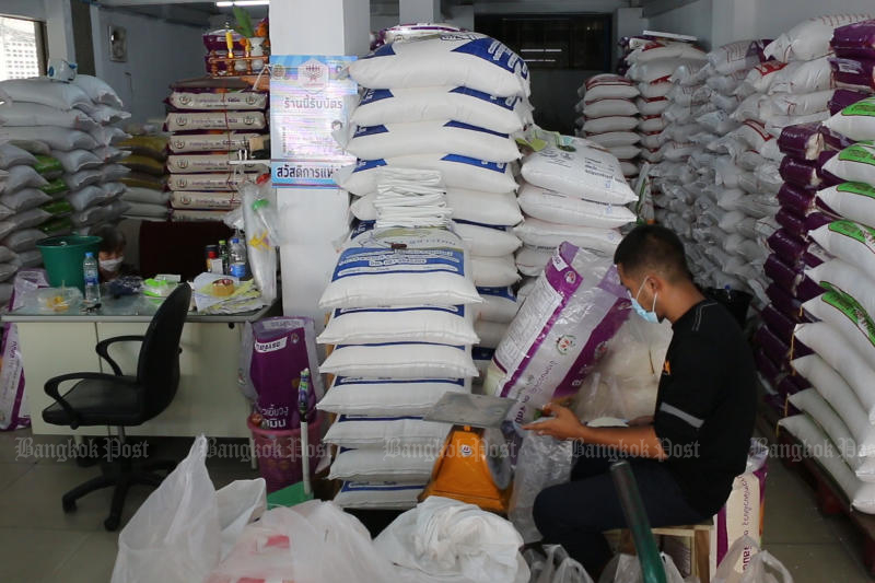 A worker weighs sacks of rice at a market in Khon Kaen province on May 27, 2022. (Photo: Chakrapan Natanri)