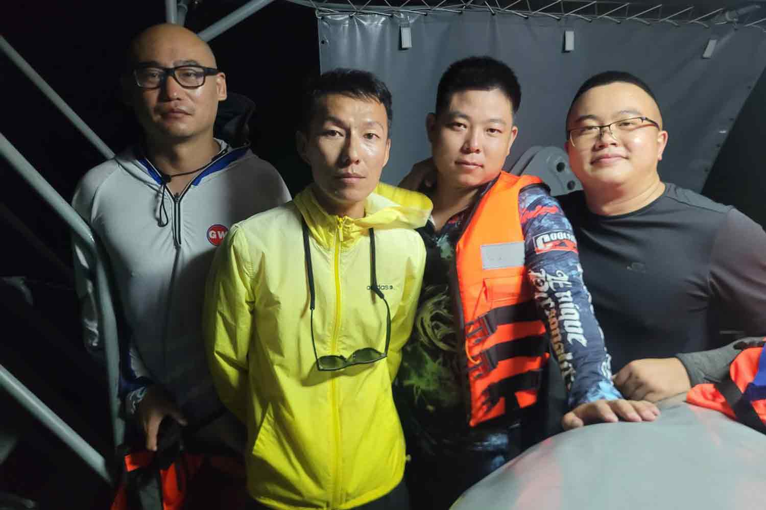 Launch owner Ren Jinyuan, second left, and his friends on the navy patrol boat Tor 233 after being rescued from their broken down boat near Koh Racha Noi of Phuket early Wednesday morning. (Photos: the navy)