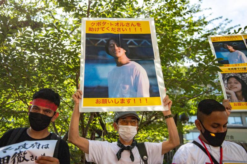 Activists holding up placards with images of Japanese film maker Toru Kubota, who has been jailed in Myanmar, during a rally in front of the Ministry of Foreign Affairs in Tokyo on July 31. (Photo: AFP)