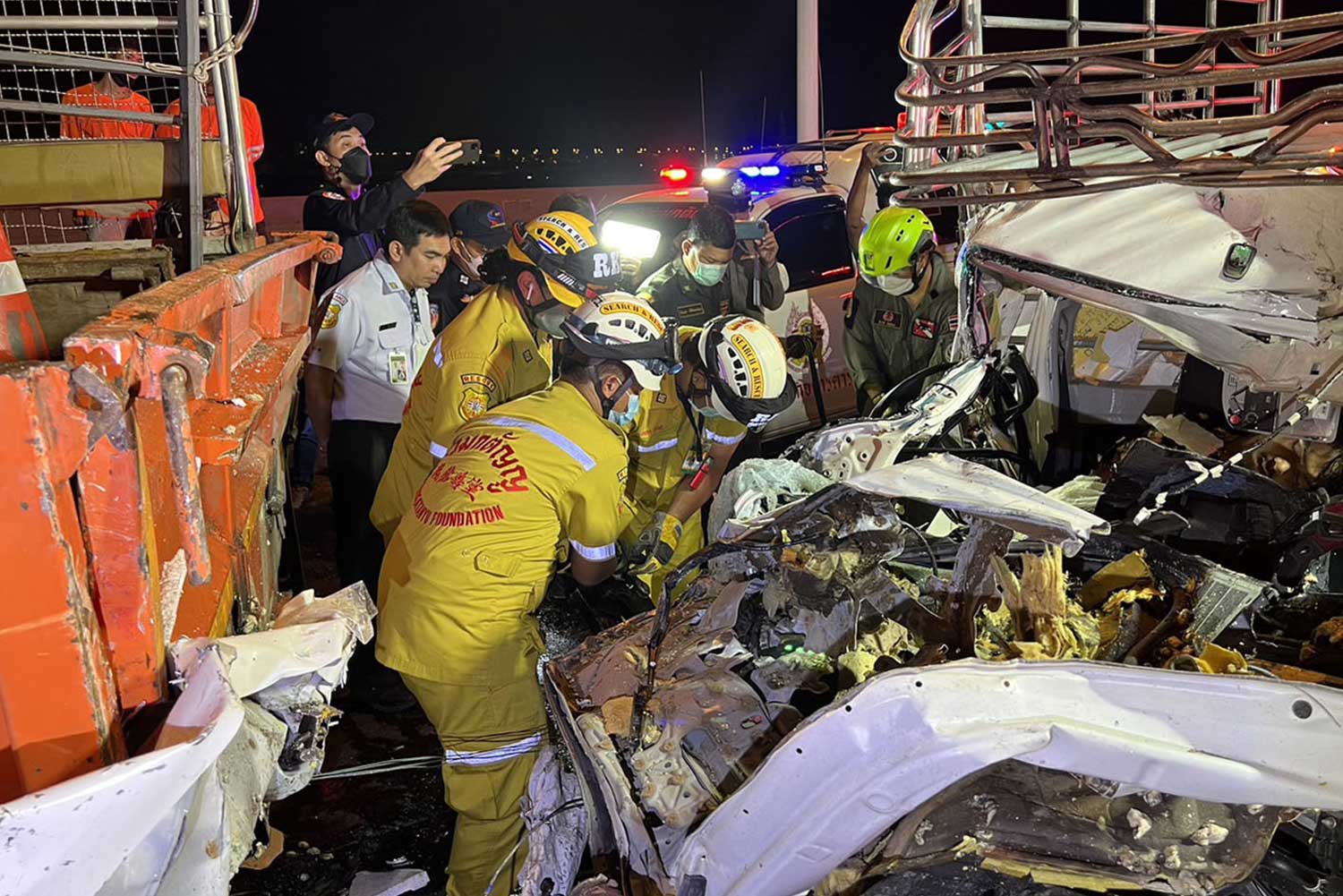 Rescue workers extract the injured from the wreckage of a pickup truck after the accident on the Burapha Withi expressway. One man was killed and four other people injured in the three-vehicle crash. (Photo supplied/ Sutthiwit Chayutworakan)