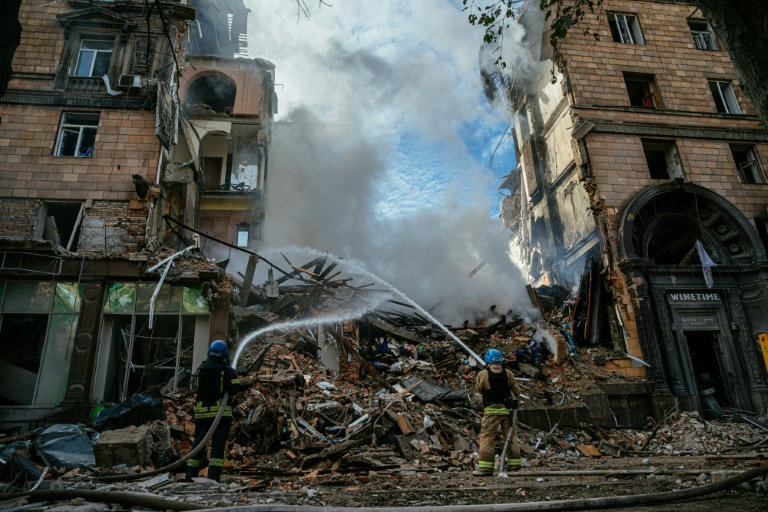 Ukrainian firefighters put out a fire after a strike in Zaporizhzhia on October 6. Ukrainian firefighters put out a fire after a strike in Zaporizhzhia on October 6.