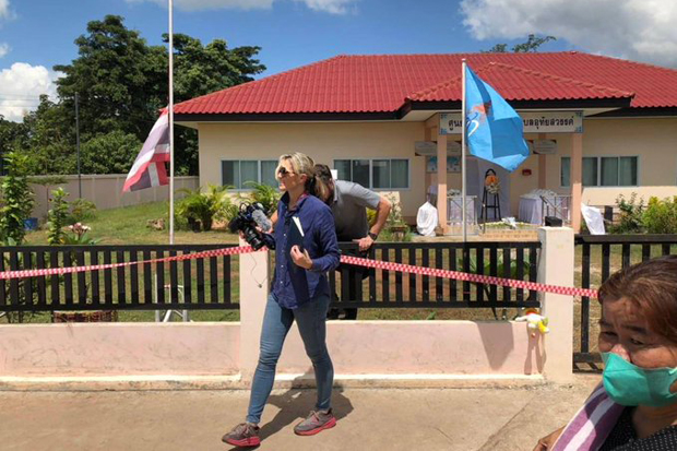 A CNN team is seen on Saturday climbing over the fence of the childcare centre in Na Klang district of Nong Bua Lamphu, the main crime scene of the massacre. (Photo: A Thai journalist via @FCCThai Twitter account)