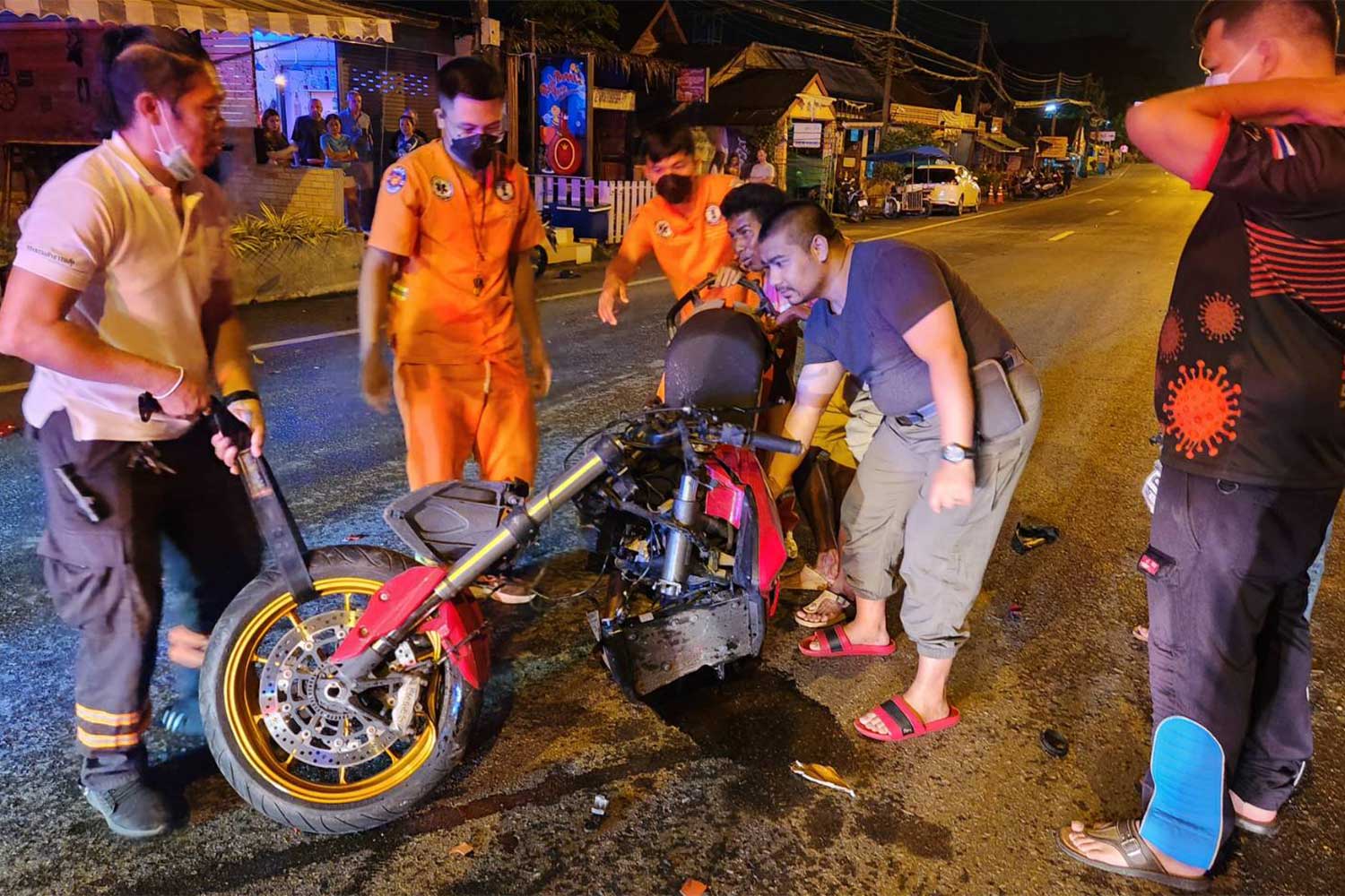 Rescue workers with the crashed Ducati motorcycle on Wiset Road in Rawai area, Muang district of Phuket, on Friday morning. Two Russian nationals and a Thai woman died in the three-vehicle accident, and two other people were injured. (Photo supplied/Achadthaya Chuenniran)