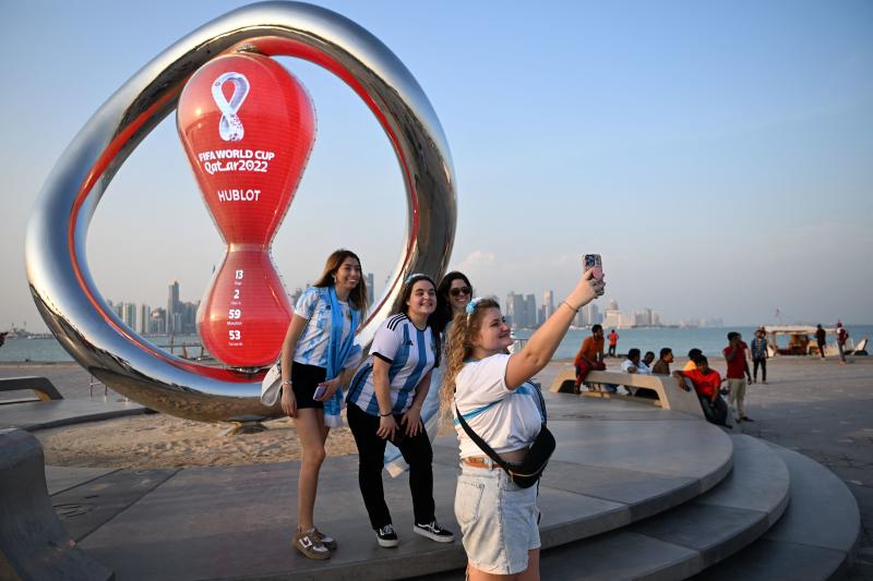 Argentina's fans take photos with the FIFA World Cup countdown clock in Doha on Monday ahead of the Qatar 2022 FIFA World Cup football tournament. (AFP photo)