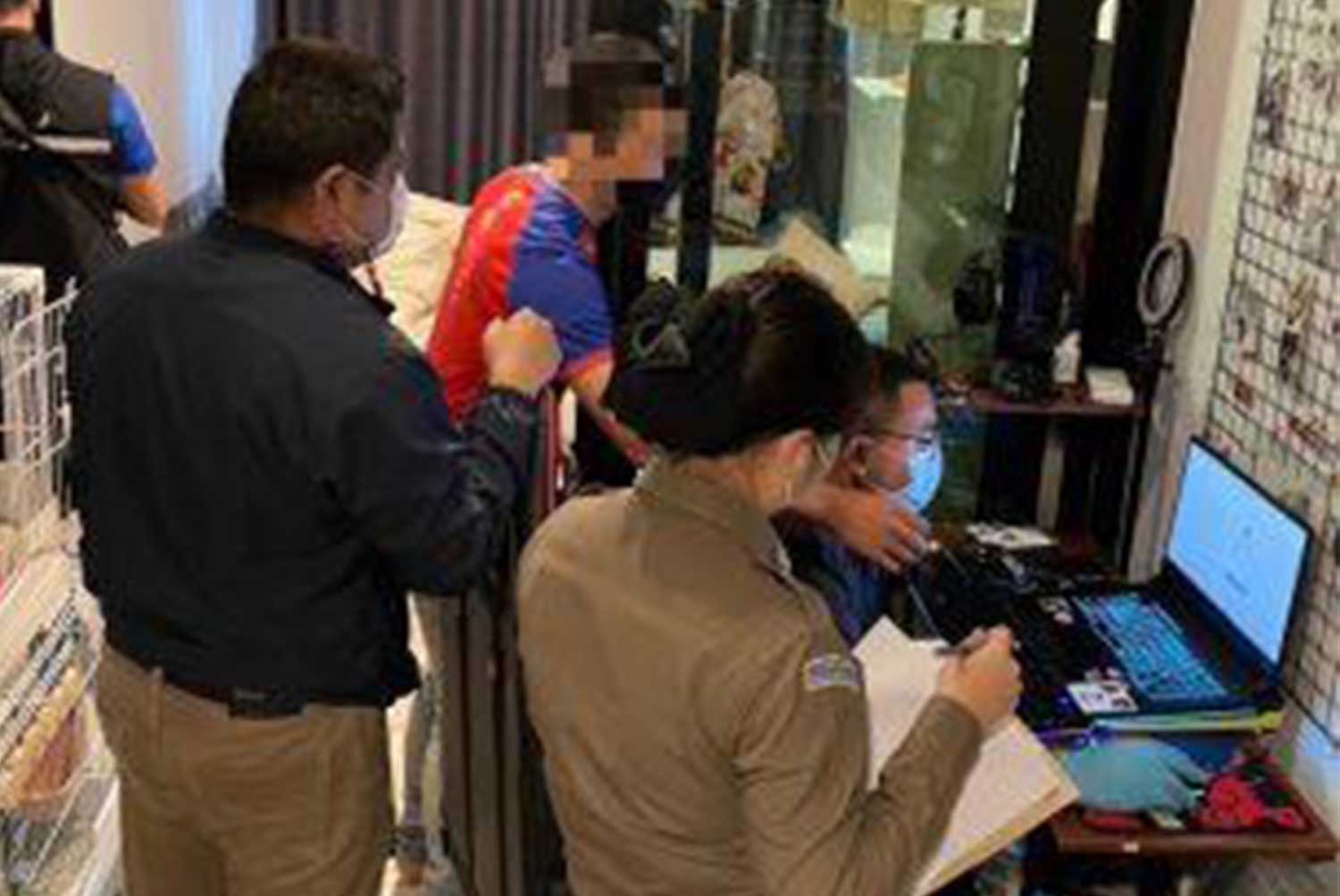 Natdanai, 28, a teacher in Samut Prakan, blurred face, is arrested at his condominium room in Bang Na district, Bangkok on Tuesday for allegedly selling videos of children, on VK social media platform. (Police photo)