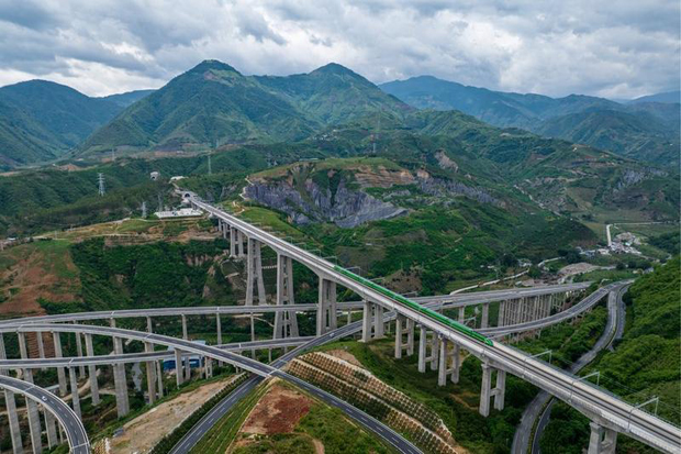 An aerial photo shows a bullet train running through Nanxihe grand bridge on the China-Laos Railway in southwest China's Yunnan province on June 2, 2022. (Xinhua photo)