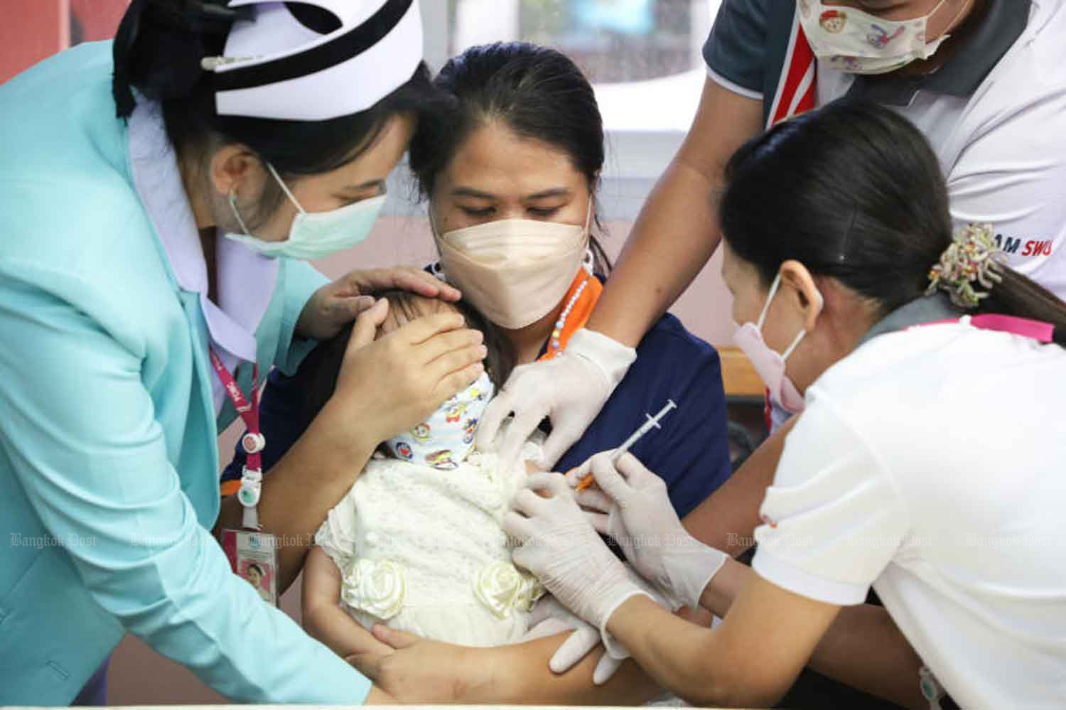 Health professionals vaccinate an infant against Covid-19 at the Phaya Thai Babies’ Home in Pak Kret district of Nonthaburi earlier this month. (Photo: Pattarapong Chatpattarasill)