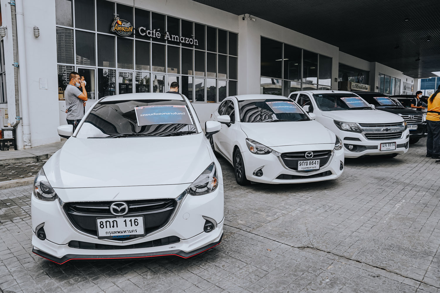 Some of the 64 cars seized during raids on seven locations in Nonthaburi are displayed by Crime Suppression Division police. (Photo supplied/ Wassayos Ngamkham)