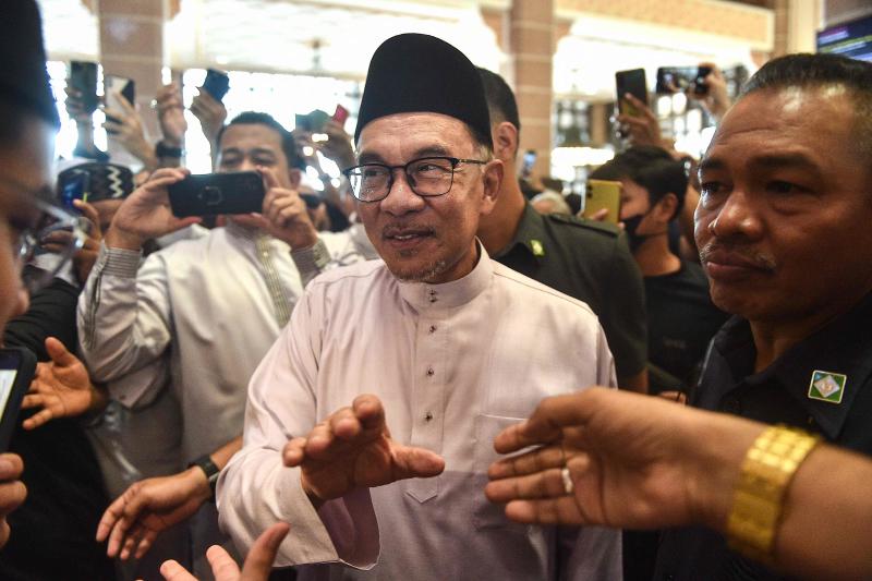 Malaysia's Prime Minister Anwar Ibrahim greets people as he leaves Putra Mosque after prayers in Putrajaya on Friday. (AFP photo) Malaysia's Prime Minister Anwar Ibrahim greets people as he leaves Putra Mosque after prayers in Putrajaya on Friday. (AFP photo)