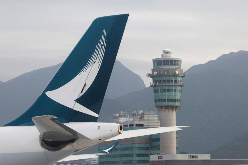 A Cathay Pacific aircraft is seen in front of air traffic control tower at Hong Kong International Airport on Oct 24, 2020. (Reuters photo)