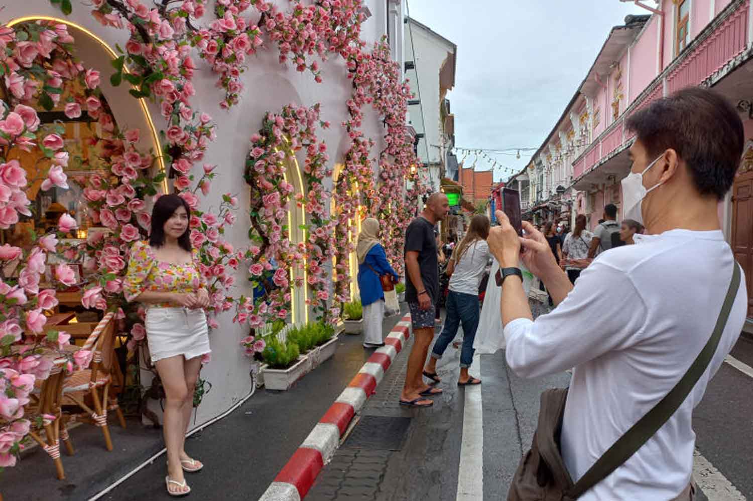 Tourists take pictures in Phuket's Old Town zone last month. (Photo: Achadthaya Chuenniran)