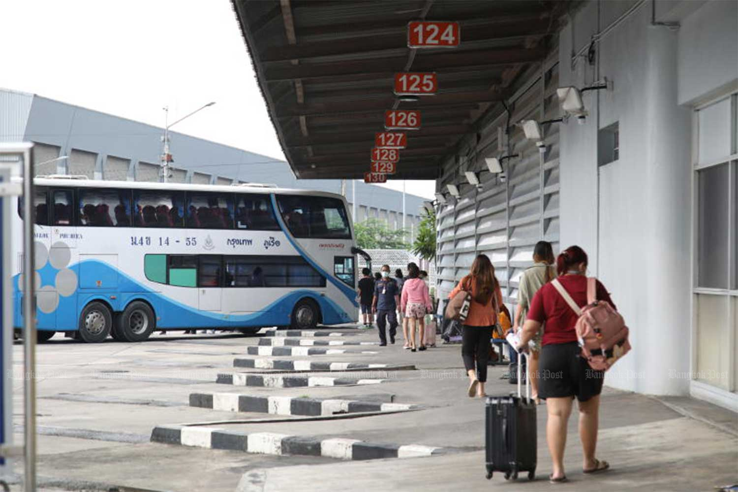 Passengers take an interprovincial bus to Loei province at Mor Chit bus terminal. State-run Transport Co plans 3,500 trips a day by bus and van services leading into the New Year. (File photo: Arnun Chonmahatrakool)