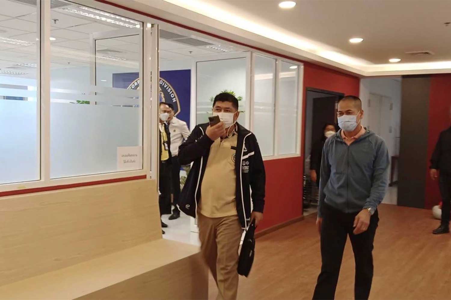 The Department of National Parks, Wildlife and Plant Conservation director-general Rutchada Suriyakul Na Ayutya, in yellow T-shirt and black jacket, is taken to the Counter Counter Corruption Division (CCD) to hear charges of malfeasance and demanding bribes. (Photo supplied/ Wassayos Ngamkham)