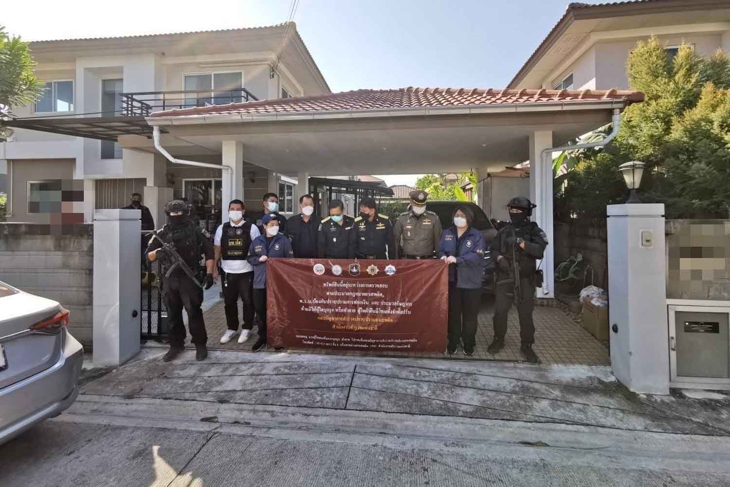 Police pose for pictures at a house impounded during coordinated drug raids in nine provinces last month. (Photo supplied)