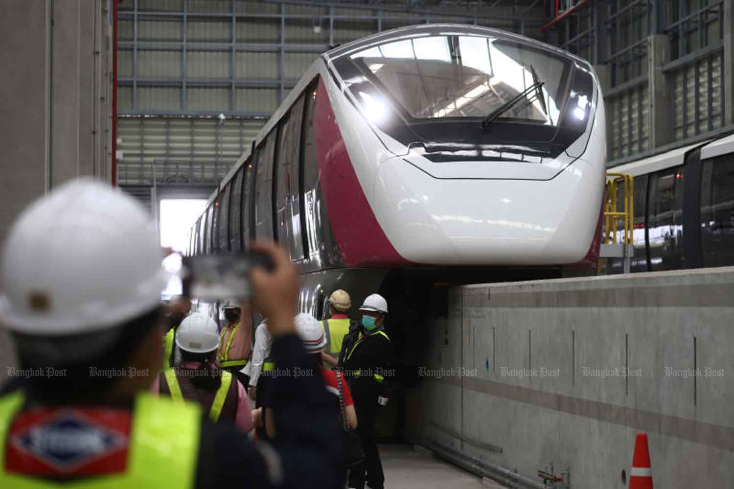 Media and officials observe a Pink Line electric train at its depot in Min Buri in April last year. (Photo: Nutthawat Wicheanbut)