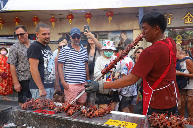 Tourists visit Yaowarat Road, home to Bangkok's Chinatown, on Sunday, which marks this year's Lunar New Year. (Photo: Varuth Hirunyatheb)