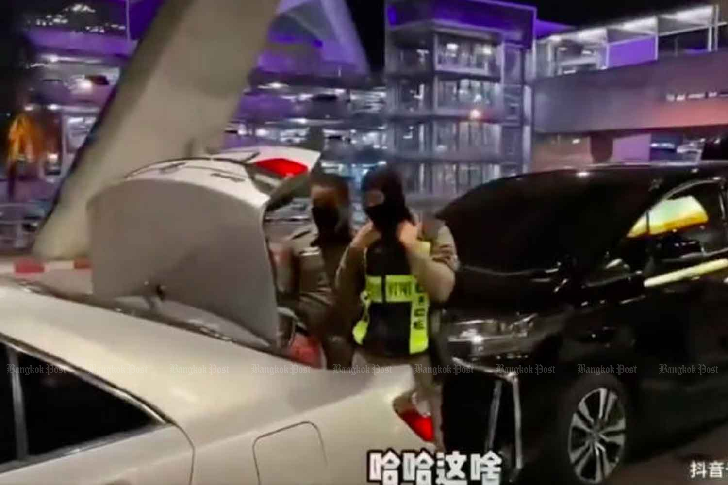 The picture captured from a viral video clip posted by a tourist from Hong Kong show a two policemen load her luggage into a car trunk.